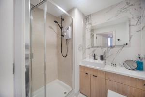 a bathroom with a shower and a sink at Mearns Street Suite ✪ Grampian Lettings Ltd in Aberdeen