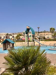 a playground with a slide in a swimming pool at Rest, sea and sun in Agadir