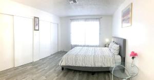a bedroom with a bed and a glass table at Super 1 bedroom with private bathroom, shared kitchen room -3 in Las Vegas