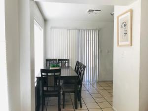 a dining room with a black table and chairs at Super 1 bedroom with private bathroom, shared kitchen room -3 in Las Vegas