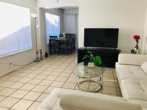 a living room with a couch and a table at Super 1 bedroom with private bathroom, shared kitchen room -3 in Las Vegas