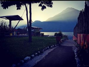 a path leading to a beach with a mountain in the background at PEDACITO DE CIELO in Santiago Atitlán
