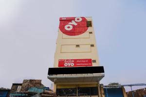 a building with a sign on the side of it at 69076 OYO Hotel Sweekar in Shamshabad