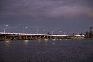 a bridge over a body of water with ducks on it at Reflections Forster Beach - Holiday Park in Forster