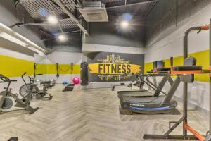 a fitness room with bikes and a gym at WINK Aparthotel One Thibault in Cape Town