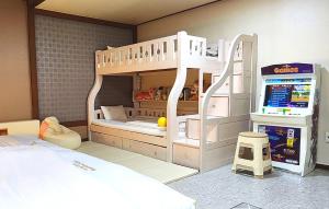 a childs bedroom with a bunk bed with a ladder at GyeongJu Kids & Family Hotel in Gyeongju