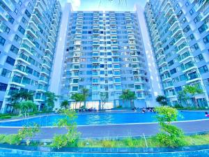 a large apartment building with a tennis court in front of it at Hue Oi Homestay - Spacious 3-Bedroom Apartment with Balcony & Pool in Hue
