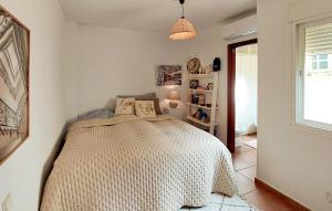 a bedroom with a bed in a room with a window at Awesome Apartment In Fuengirola in Fuengirola