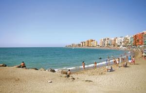 a group of people on a beach near the ocean at Awesome Apartment In Fuengirola in Fuengirola