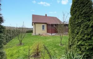 a house in the middle of a yard with trees at Stunning Home In Trynisze Moszewo With Wifi in Ciechanowiec