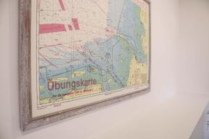 a map of singapore hanging on a wall at Orange Hygge Haus in Langeoog