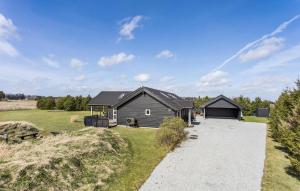 a house with a garage and a driveway at Gorgeous Home In Jerup With Sauna in Jerup