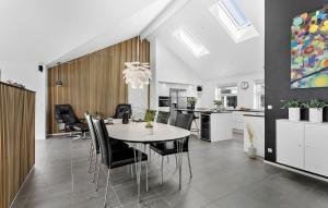 a dining room and kitchen with a table and chairs at Gorgeous Home In Jerup With Sauna in Jerup