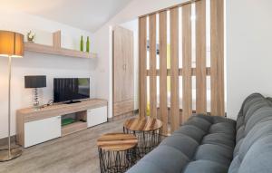 a living room with a couch and a tv at Amazing Apartment In Fuente De Piedra With Outdoor Swimming Pool in Fuente de Piedra