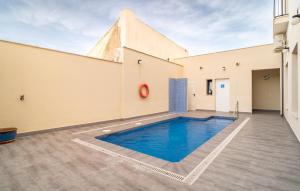 a swimming pool in the middle of a building at Amazing Apartment In Fuente De Piedra With Outdoor Swimming Pool in Fuente de Piedra