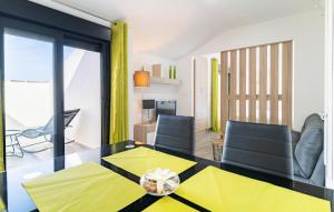 a living room with a glass table and chairs at Amazing Apartment In Fuente De Piedra With Outdoor Swimming Pool in Fuente de Piedra