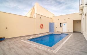 a swimming pool in the middle of a building at Cozy Apartment In Fuente De Piedra With Swimming Pool in Fuente de Piedra