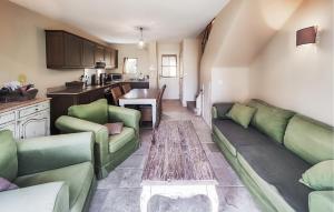 a living room with green couches and a table at Beautiful Home In Saint-Laurent-De-La-Cabrerisse in Saint-Laurent-de-la-Cabrerisse