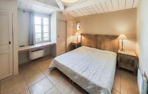 a bedroom with a large bed and a window at Beautiful Home In Saint-Laurent-De-La-Cabrerisse in Saint-Laurent-de-la-Cabrerisse