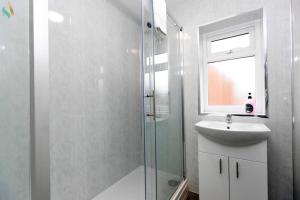 a bathroom with a glass shower and a sink at Gilside Lodge in Stockton-on-Tees