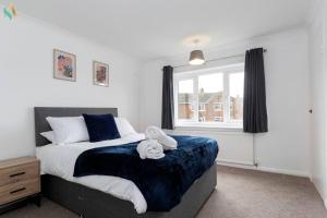 a bedroom with a bed with two towels on it at Gilside Lodge in Stockton-on-Tees
