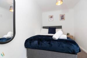 a bedroom with a large bed with a mirror at Gilside Lodge in Stockton-on-Tees