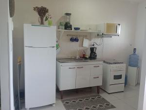 a kitchen with a white refrigerator and a microwave at Seu apto em Pnz in Petrolina