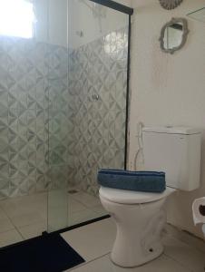 a bathroom with a toilet with a blue towel on it at Seu apto em Pnz in Petrolina