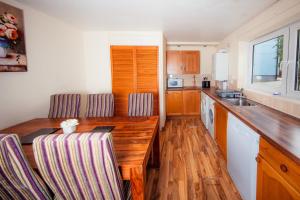 a kitchen with a wooden table and chairs at Fab Arthur Seat Views, Old Town Apartment in Edinburgh