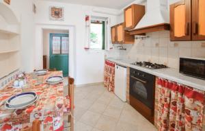 a kitchen with a table with plates on it at 1 Bedroom Cozy Apartment In Reggimonti in Reggimonti