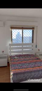 a bedroom with a large bed with a window at مزرعة كراون in Umm el ‘Amad