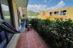 a balcony with a hammock outside of a building at The Refuge#1 Lovely 2 BR-Apt pool & good vibes in Santa Marta