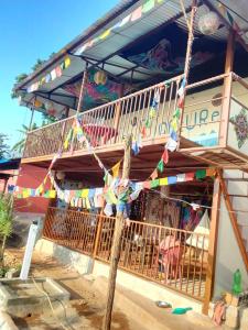 a house with a balcony with flags on it at Return to Nature Homestay in Nawākot