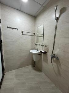 a bathroom with a sink and a shower at Mami House - Tecco Elite City Thai Nguyen Serviced Apartments in Thái Nguyên