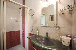 a bathroom with a sink and a mirror at Luxury villa with chef/bartender - La Cosa Nostra in Colva