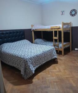 a bedroom with two bunk beds and a desk at Houselyon in Mendoza