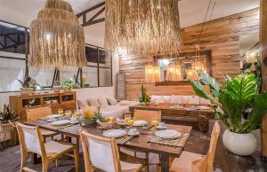 a dining room with a table and a couch at Villa Kosibali by Optimum Bali Villas in Kerobokan