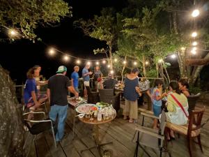 a group of people standing around a patio at night at Yamamizuki in Shimanto