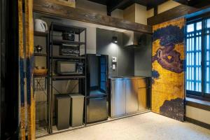 a kitchen with a wall with a painting on it at Asagi an Machiya House in Kyoto
