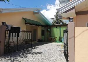 a house with a gate in front of it at CG'S TRAVELLERS INN in Panglao