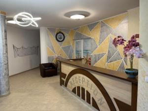 a living room with a lobby with a tile wall at Aparthotel Costa Calma in Aheloy +106 photos
