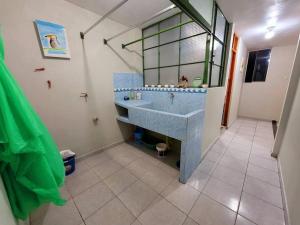 a bathroom with a blue sink and a mirror at Amplio Departamento Amoblado de Estreno in Cajamarca