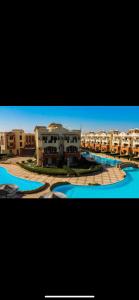 a group of apartment buildings and a river with buildings at La sirena double room with mountain view, Families and couples only, Extra of 180 Egyptian pounds per adult person per stay ,to be paid to the resort in Ain Sokhna