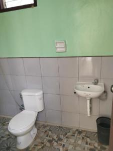 a bathroom with a toilet and a sink at Xylla Guesthouse in Siquijor