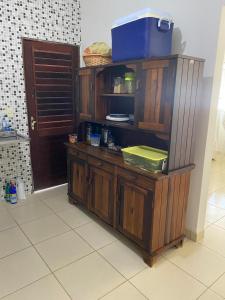 a wooden counter in a kitchen with a door at Residencial Sauaçhuy in Ipioca