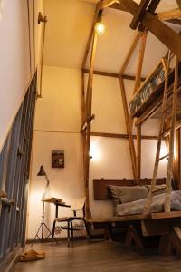 a room with two bunk beds and a desk at Stilt House - Tre Dalat in Da Thien +13 photos