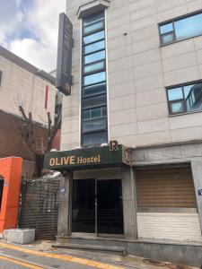 a building with an olive hospital sign on it at Olive hostel R(Residence) in Seoul