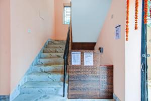 a staircase in a house with blue marble floors at Super Hotel O Shree Residency in Thākurdwari
