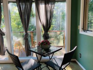 a room with a table and chairs and a window at Creekside private suite in North Vancouver