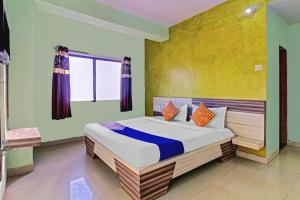a bedroom with a large bed in a room at SPOT ON Shreekrupa in Mahabaleshwar